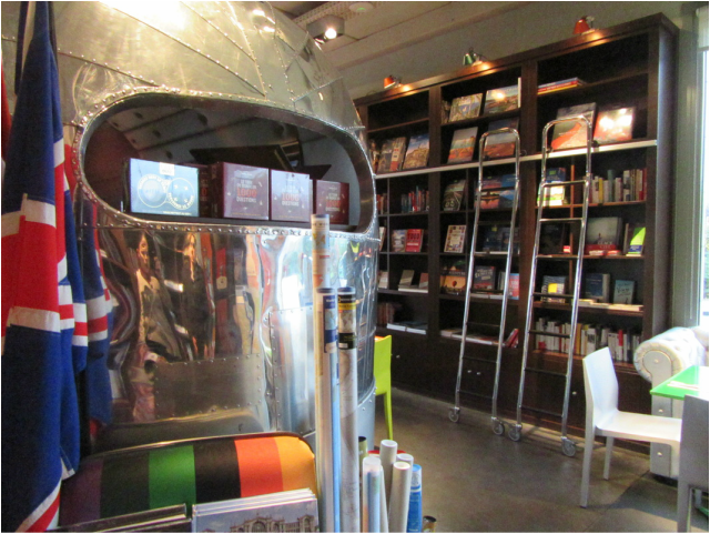 Travel bookstore section with a vintage camper inside